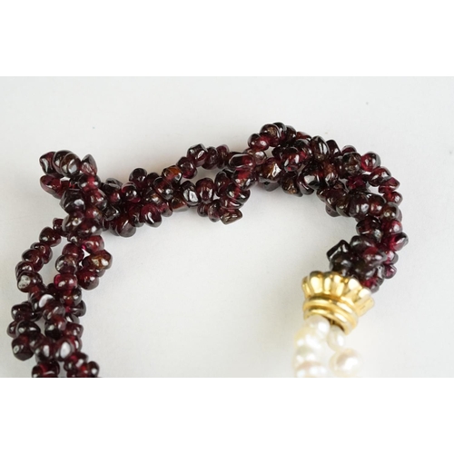 189 - A garnet and natural pearl necklace together with a white metal marcasite brooch in the form of scal... 