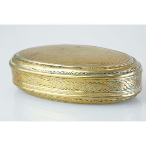 374 - An antique 18th century oval brass snuff box with ornate chased decoration.