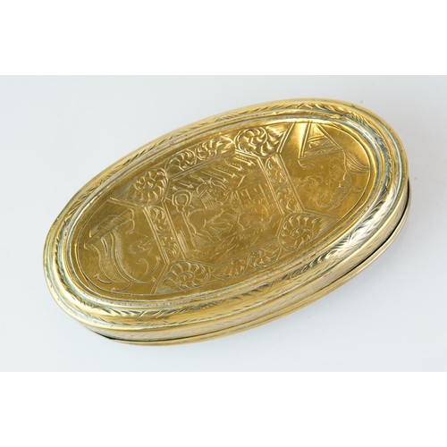 374 - An antique 18th century oval brass snuff box with ornate chased decoration.