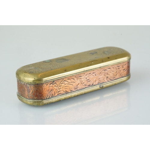 375 - An antique 18th century brass and copper snuff box with ornate chased decoration.