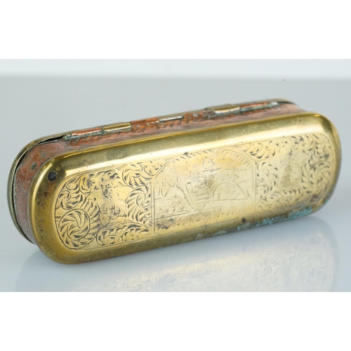 375 - An antique 18th century brass and copper snuff box with ornate chased decoration.