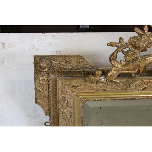 571 - 19th century Gilt Framed Mirror, the scrolling crest holding a face mask and with moulded floral det... 