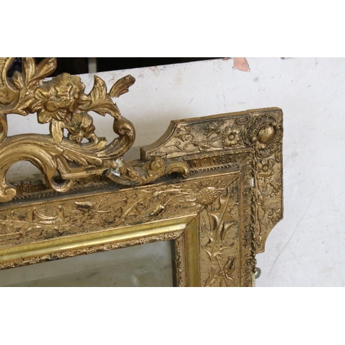 571 - 19th century Gilt Framed Mirror, the scrolling crest holding a face mask and with moulded floral det... 