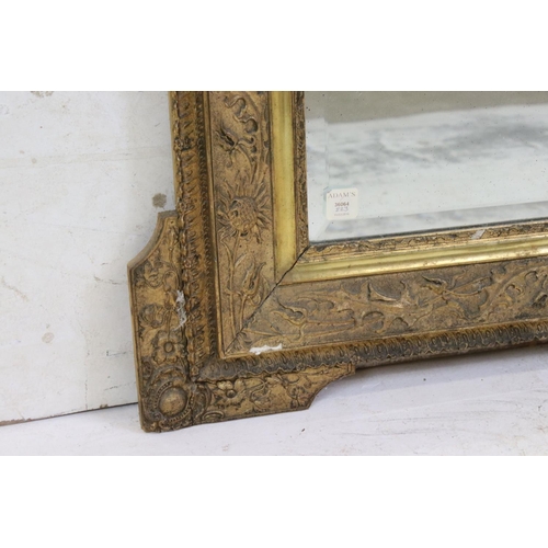 571 - 19th century Gilt Framed Mirror, the scrolling crest holding a face mask and with moulded floral det... 