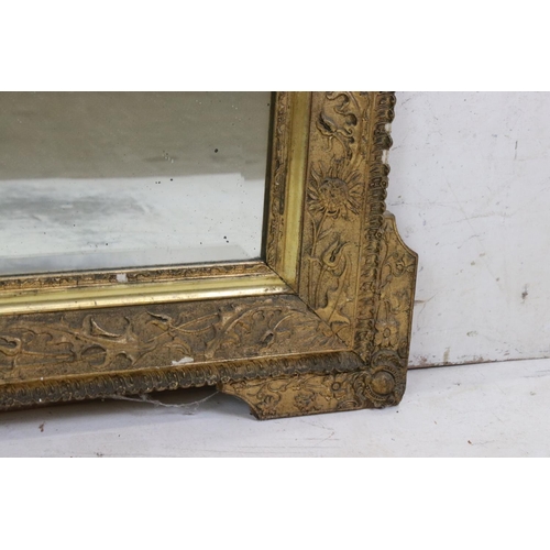 571 - 19th century Gilt Framed Mirror, the scrolling crest holding a face mask and with moulded floral det... 