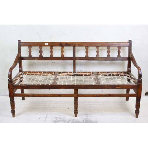 575 - Regency Mahogany Hall Bench, with open arms, webb seat in need of upholstery, raised on turned legs,... 