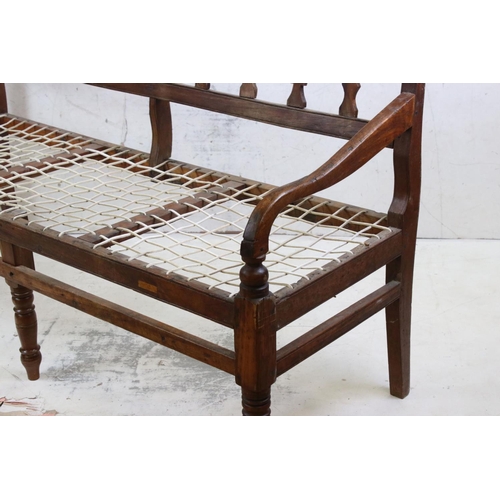 575 - Regency Mahogany Hall Bench, with open arms, webb seat in need of upholstery, raised on turned legs,... 