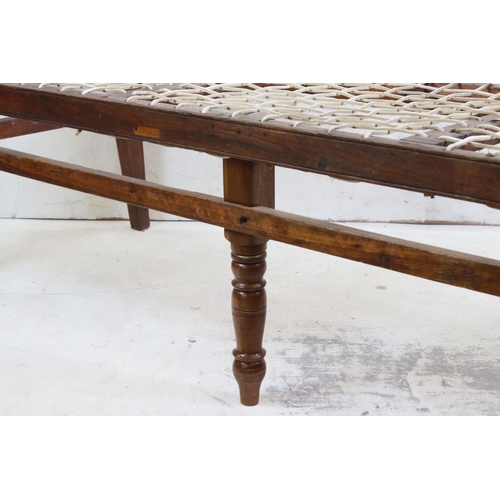 575 - Regency Mahogany Hall Bench, with open arms, webb seat in need of upholstery, raised on turned legs,... 