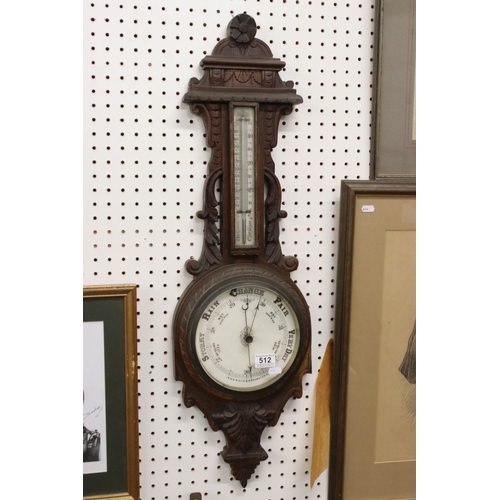 512 - A late 19th / Early 20th Century carved oak wheel barometer, with mercury thermometer and aneroid ba... 