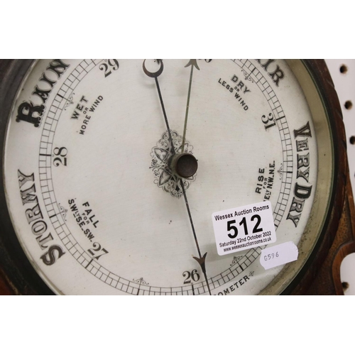 512 - A late 19th / Early 20th Century carved oak wheel barometer, with mercury thermometer and aneroid ba... 