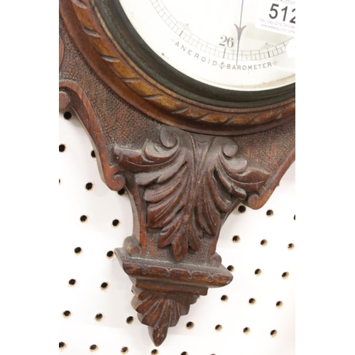 512 - A late 19th / Early 20th Century carved oak wheel barometer, with mercury thermometer and aneroid ba... 