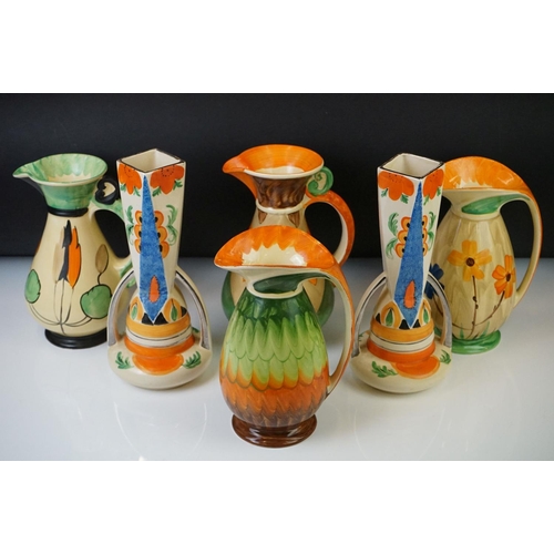 14 - Four Myott, Son & Co hand painted Art Deco footed jugs, decorated with colourful floral, foliate and... 