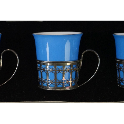 22 - Boxed Shelley Blue glazed coffee set to include six coffee cans in silver hallmarked handled mounts ... 