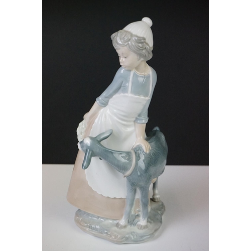 27 - Six Nao by Lladro porcelain figures to include a girl with a goat (29.5cm high), a tailor and a youn... 