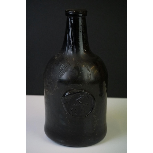 28 - A dark green glass mallet shaped wine bottle
18th century, bearing a seal with the initials 'G.B' be... 