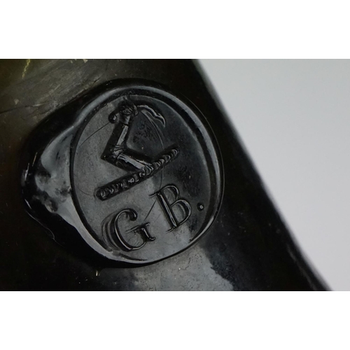 28 - A dark green glass mallet shaped wine bottle
18th century, bearing a seal with the initials 'G.B' be... 