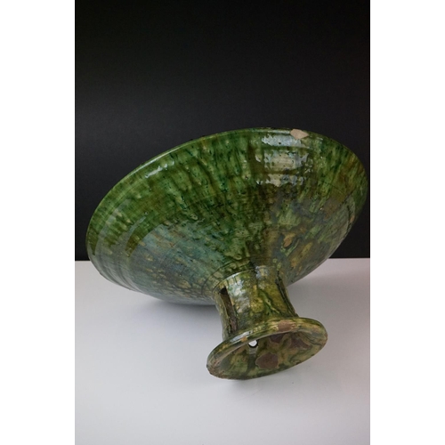 35 - Large French Artisan green glazed pottery circular footed bowl of conical form, 41cm diameter