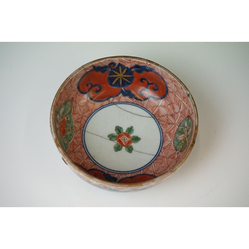 52 - Near pair of Chinese porcelain circular geometric red ground bowls bowls with red and green foliate ... 