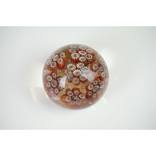 62 - A millefiori glass paperweight of mushroom shape, with a central cluster of eight canes flanked by s... 