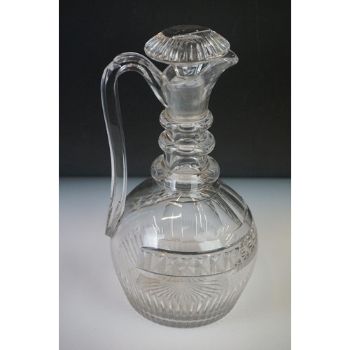 80 - Three cut glass decanters with star-cut bases to include two in the form of ewers and another with a... 