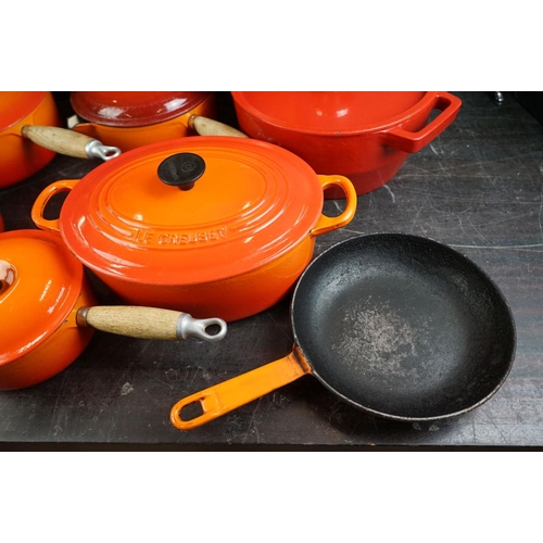 101A - Le Creuset Orange Cast Iron and Enamel Ovenware, 8 items, to include a frying pan, 5 lidded saucepan... 