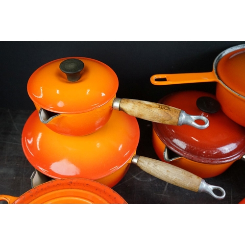 101A - Le Creuset Orange Cast Iron and Enamel Ovenware, 8 items, to include a frying pan, 5 lidded saucepan... 