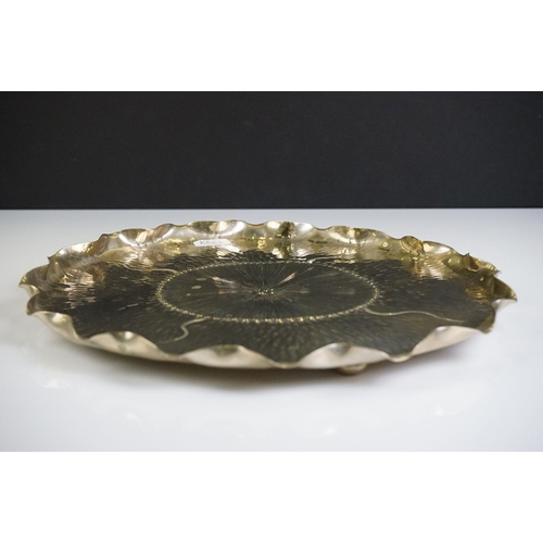 109 - An unusual Aesthetic period plated tray of shaped circular outline of lily pad design and hammered d... 