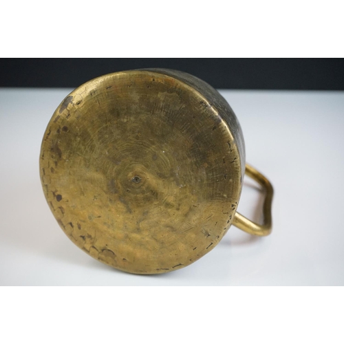 111 - Islamic brass jug of tapering form, heavily decorated with chased decoration, 15cm high