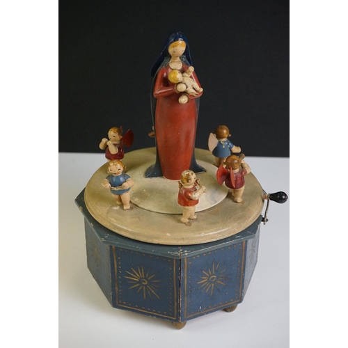 115 - A German painted wooden musical carousel of octagonal form surmounted by Mary holding the baby Jesus... 