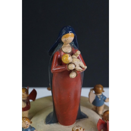 115 - A German painted wooden musical carousel of octagonal form surmounted by Mary holding the baby Jesus... 