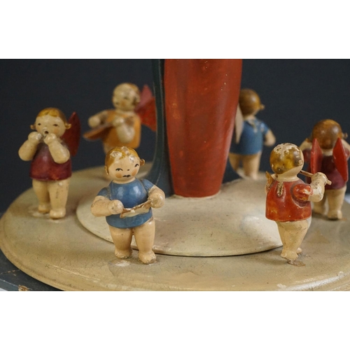 115 - A German painted wooden musical carousel of octagonal form surmounted by Mary holding the baby Jesus... 