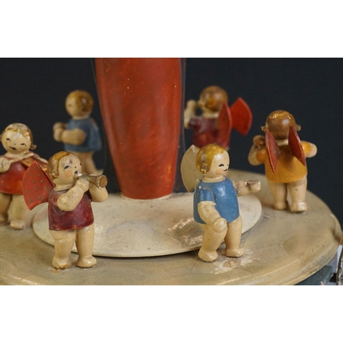 115 - A German painted wooden musical carousel of octagonal form surmounted by Mary holding the baby Jesus... 