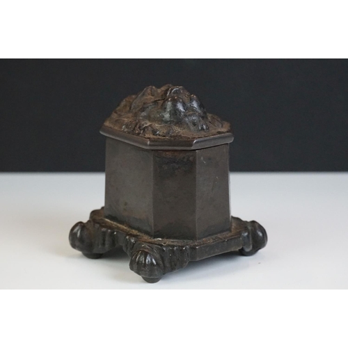 117 - A Georgian cast iron tobacco jar, the lions head lid above a base impressed 