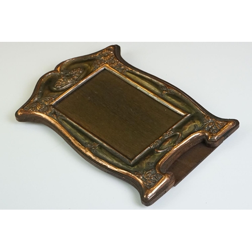 128 - Art Nouveau Style Copper Mounted Wooden photo frame with relief floral decoration and a vacant carto... 