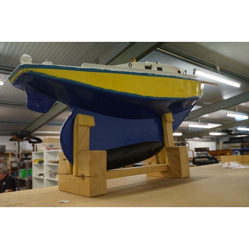 130 - Scratch-built painted wooden model of a yacht, in blue, yellow and white, with decking and hatch det... 