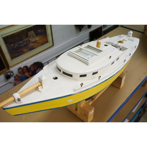 130 - Scratch-built painted wooden model of a yacht, in blue, yellow and white, with decking and hatch det... 