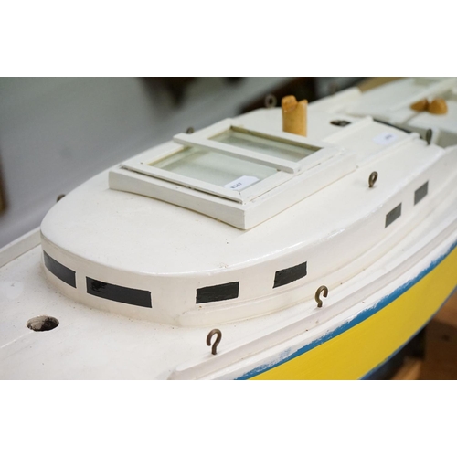 130 - Scratch-built painted wooden model of a yacht, in blue, yellow and white, with decking and hatch det... 