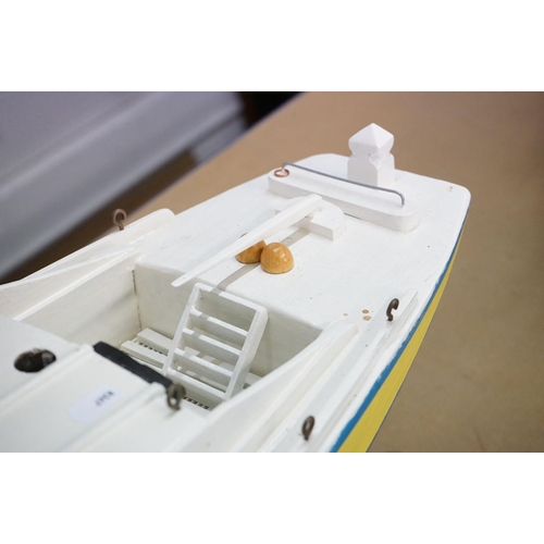 130 - Scratch-built painted wooden model of a yacht, in blue, yellow and white, with decking and hatch det... 