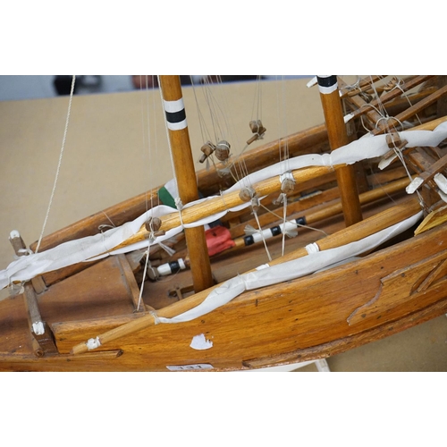 131 - Scratch-built painted wooden model of a sailing ship, with two masts, sails and rigging details, app... 