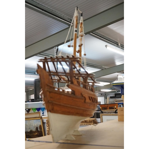 131 - Scratch-built painted wooden model of a sailing ship, with two masts, sails and rigging details, app... 