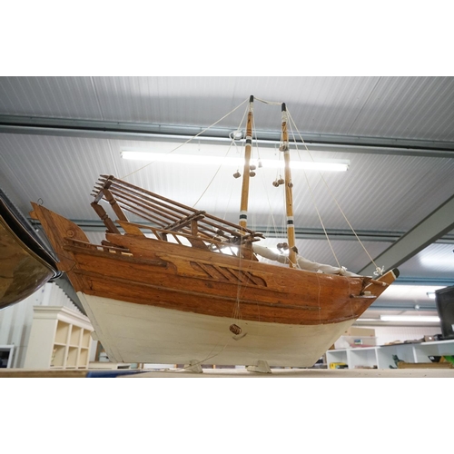 131 - Scratch-built painted wooden model of a sailing ship, with two masts, sails and rigging details, app... 