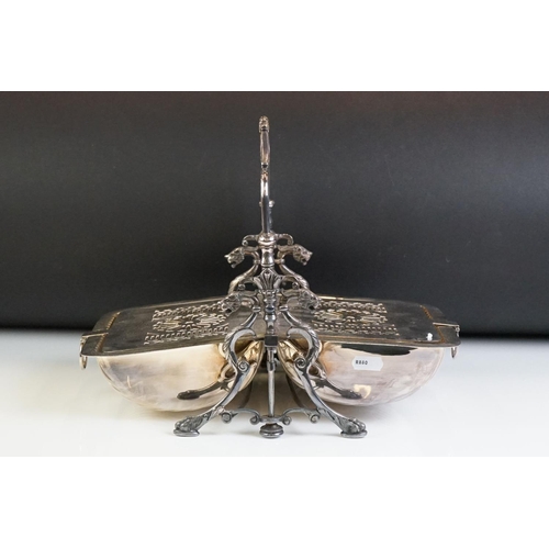 142 - Silver plated folding entrée dish, with cast dragon decoration to the sides, raised on four hoof-lik... 