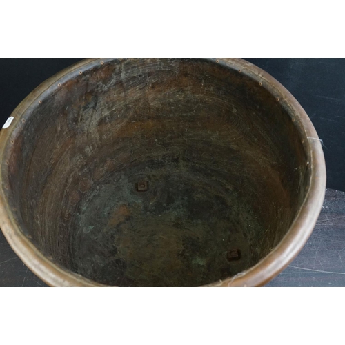 150 - Antique copper studded coal bucket / planter, raised on three feet, 51cm diameter x 37cm high