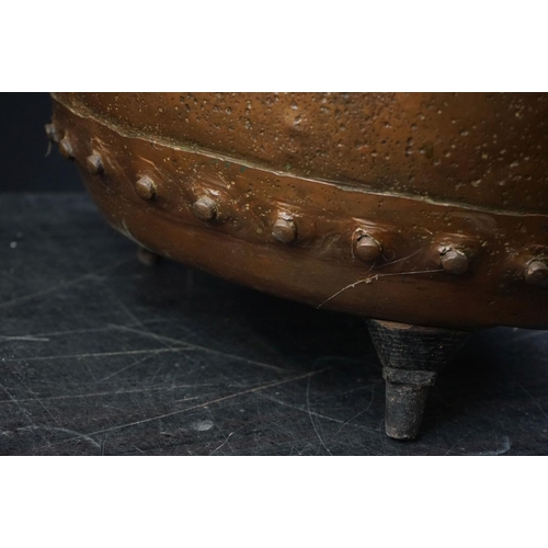 150 - Antique copper studded coal bucket / planter, raised on three feet, 51cm diameter x 37cm high