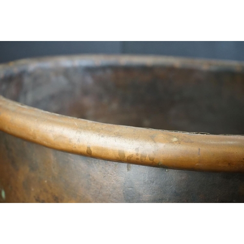 150 - Antique copper studded coal bucket / planter, raised on three feet, 51cm diameter x 37cm high