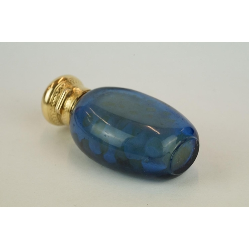 207 - Blue glass scent bottle, yellow metal lid with engine turned decoration, opening to reveal original ... 