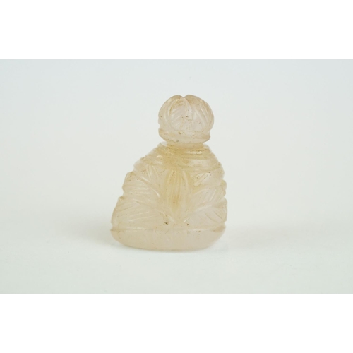 217 - Rose quartz miniature scent bottle of asymmetric form, carved with foliate decoration, height approx... 