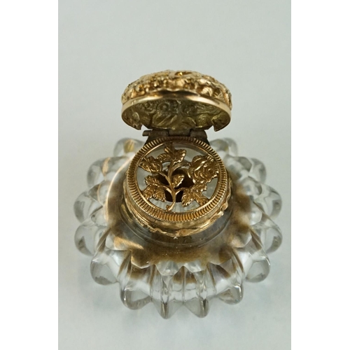 236 - Vinaigrette of bottle form, squat glass body, yellow metal collar and hinged lid, repousse rose and ... 