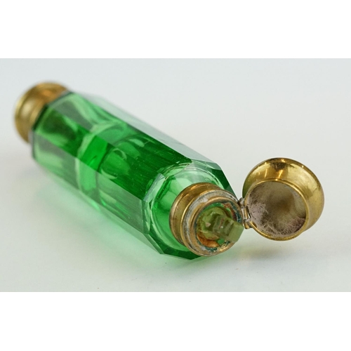 243 - 19th century green glass double ended gilt scent bottle, each end containing original stopper, lengt... 