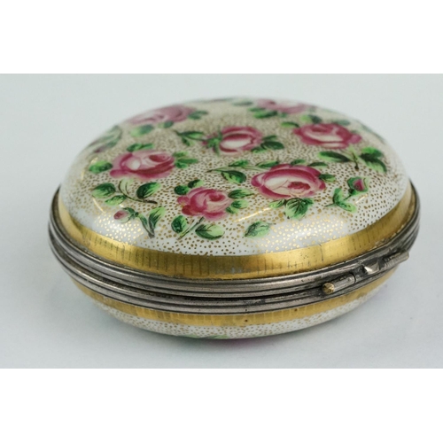 256 - Continental ceramic and white metal circular trinket box with hand-painted roses to the outside and ... 